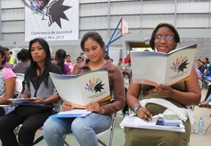 Des jeunes étudiant le programme de la conférence à San Jose, au Costa Rica.