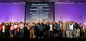 En point d’orgue de la conférence, les bahá’ís irlandais montèrent sur scène, entraînant l’assemblée dans leur chant.