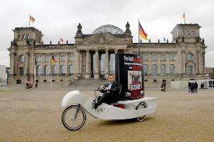 Au bâtiment historique du Reichstag à Berlin, le Membre du Parlement Serkan Tören a circulé sur un vélo spécial exposant l’image des sept responsables baha’is emprisonnés en Iran.
