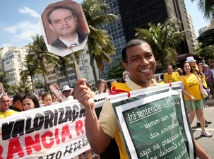 Un participant à la marche pour la Liberté religieuse de Rio – qui a eu lieu le 18 septembre 2011 – porte une bannière représentant M.Vahid Tizfahm, l’un des sept responsables bahá’ís emprisonnés en Iran.
