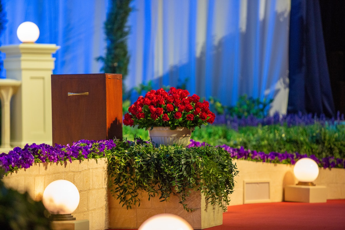 Un bouquet de roses rouges a été offert à la Convention au nom des bahá’ís d’Iran qui, en raison de la persécution continue dans leur pays d’origine, n’ont pas pu assister au rassemblement ni participer aux élections. Les fleurs sont placées sur la scène, au premier plan, lors des sessions de la Convention à Haïfa.